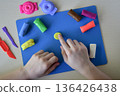 plasticine sweets candy and lollipops food modeling for children flat lay step 4 adding texture and shape to handmade sweets creative diy craft educational activity fine motor skills concept 136426438