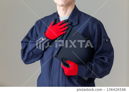 Middle-aged male businessman in work clothes holding his hand on his chest 136426586