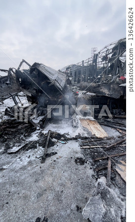 A large truck burned down at the site of the missile attack.  136426624
