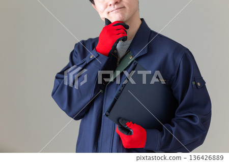 A middle-aged male businessman in work clothes who is worried A middle-aged male businessman in work clothes who is worried 136426889
