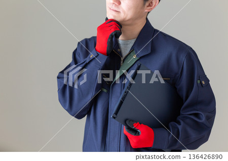 A middle-aged male businessman in work clothes who is worried A middle-aged male businessman in work clothes who is worried 136426890