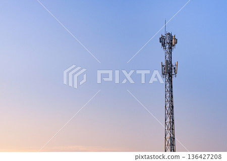 Antenna communication station tower on sunset sky Antenna communication station tower on sunset sky 136427208