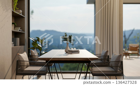 Wooden table and metal armchairs near bookshelf aside window wall and terrace with mountain scenery. Wooden table and metal armchairs near bookshelf aside window wall and terrace with mountain scenery. 136427328
