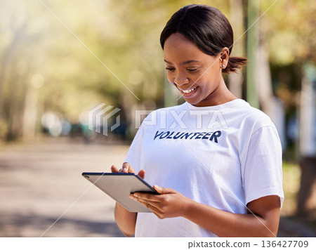 Woman, tablet and volunteering in park on social media FAQ, blog or community service website. African person on digital technology for earth day information, NGO or nonprofit sign up in nature 136427709