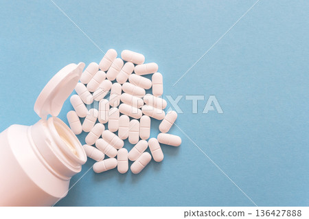 Much medical pills and drugs in white bottle on the blue background. Healthcare concept. Space for text. 136427888