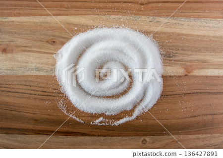 White granulated sugar for cooking food on the natural wood background. 136427891