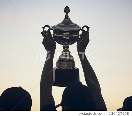 Sunset, trophy in hands and silhouette and team with sports, athlete group and people outdoor with celebration. Winning, club and success with prize, reward and bonus, sky and support and achievement Sunset, trophy in hands and silhouette and team with sports, athlete group and people outdoor with celebration. Winning, club and success with prize, reward and bonus, sky and support and achievement 136427968