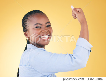 Portrait, black woman and flex for power, smile and challenge on a yellow studio background. Face, happy person and model with strength, arm muscle and achievement with success, confident and winning Portrait, black woman and flex for power, smile and challenge on a yellow studio background. Face, happy person and model with strength, arm muscle and achievement with success, confident and winning 136428082