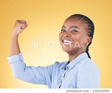 Portrait, strong and black woman flex for power, achievement and challenge on a yellow studio background. Face, happy person and model with strength, arm muscle and success with confidence or winning Portrait, strong and black woman flex for power, achievement and challenge on a yellow studio background. Face, happy person and model with strength, arm muscle and success with confidence or winning 136428084