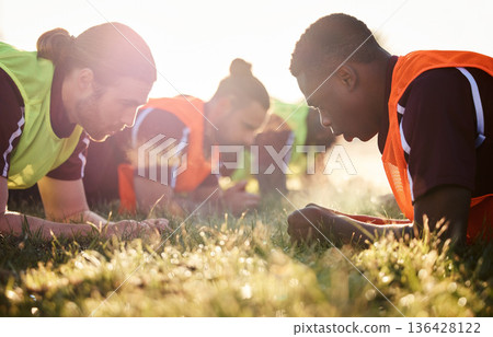 Sports, team and soccer group plank on field for fitness training, workout or core exercise outdoor in summer. Football player, club and athletes, men and focus for strength or sport challenge Sports, team and soccer group plank on field for fitness training, workout or core exercise outdoor in summer. Football player, club and athletes, men and focus for strength or sport challenge 136428122