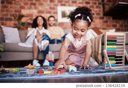 Child, toys and playing in home with development and building block in living room. Family, fun and youth learning with a young girl and parents in a house together with care and bonding education Child, toys and playing in home with development and building block in living room. Family, fun and youth learning with a young girl and parents in a house together with care and bonding education 136428138