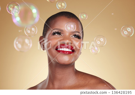 Smile, makeup and bubbles with face of black woman in studio for cosmetics, spa treatment and luxury. Skincare, dermatology and self care with model on gold background for glow, facial and beauty 136428195