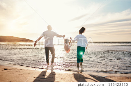 Dad, mom and swing girl on beach, holiday and vacation in Florida for bonding, adventure and family together in waves. Mother, father and child at sunset in ocean, sea or playing in water for fun Dad, mom and swing girl on beach, holiday and vacation in Florida for bonding, adventure and family together in waves. Mother, father and child at sunset in ocean, sea or playing in water for fun 136428350