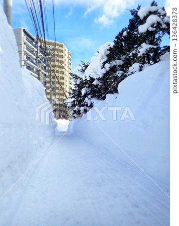 Snowy mountains on the sidewalks of Sapporo Snowy mountains on the sidewalks of Sapporo 136428378