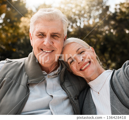 Love, portrait and senior couple hug in a forest, happy and bond in nature on a weekend trip together. Smile, face and romantic old woman embrace elderly male in woods, cheerful and enjoy retirement 136428418
