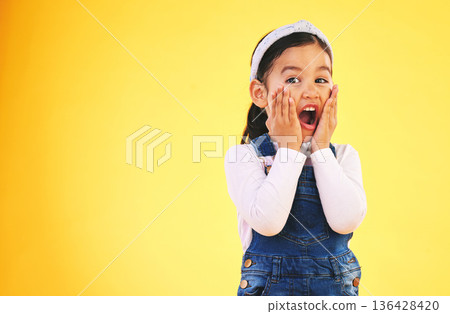 Fashion, surprise and hands on face of girl child in studio wow, omg or wtf for promo, deal or giveaway on yellow background. Portrait, emoji and kid with open mouth for news, info or clothes sale Fashion, surprise and hands on face of girl child in studio wow, omg or wtf for promo, deal or giveaway on yellow background. Portrait, emoji and kid with open mouth for news, info or clothes sale 136428420