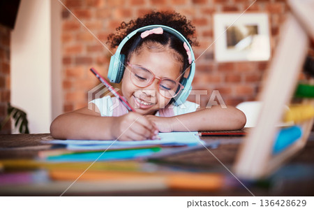 Writing, headphones and child at home with music, learning and homework for school. Kid, studying and happy with radio and audio streaming in a house with listening and drawing for creative project Writing, headphones and child at home with music, learning and homework for school. Kid, studying and happy with radio and audio streaming in a house with listening and drawing for creative project 136428629