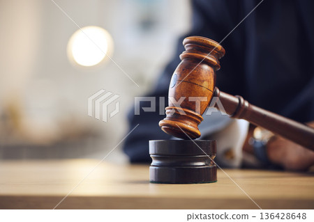 Law, judge and closeup of lawyer with gavel for justice, court hearing and legal trial for magistrate. Government, attorney career and zoom of desk for investigation, criminal case and verdict order Law, judge and closeup of lawyer with gavel for justice, court hearing and legal trial for magistrate. Government, attorney career and zoom of desk for investigation, criminal case and verdict order 136428648