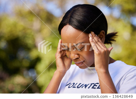 Black woman, headache and stress in mistake, debt or burnout from volunteer work in outdoor nature. Frustrated African female person with migraine, sore bruise or injury in community service in park 136428649