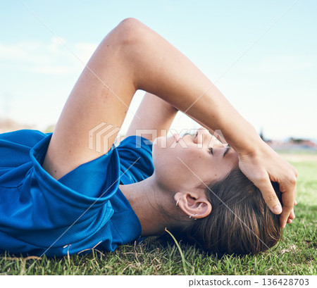 Sports, fatigue and woman with headache on a baseball field for anxiety, stress or exhaustion. Fitness, migraine and softball player on the ground with training tension, pain or mental health crisis 136428703