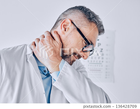 Healthcare, neck pain or optometry and a doctor in his office with an injury while feeling stress. Medical, burnout or accident with a mature optician holding his spine or shoulder in a clinic Healthcare, neck pain or optometry and a doctor in his office with an injury while feeling stress. Medical, burnout or accident with a mature optician holding his spine or shoulder in a clinic 136428709