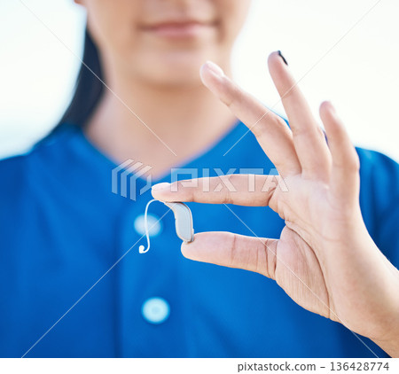 Sports, hands and a deaf person with a hearing aid for communication, baseball support or listening. Closeup, fingers and an athlete or person with a medical implant during training or fitness 136428774