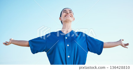 Woman, arms out and winning, softball and athlete on outdoor, celebration and success with sports. Blue sky, freedom and happiness, baseball player and fitness with achievement, cheers and winner 136428810