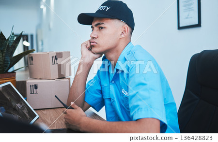 Safety, surveillance and a bored man security guard sitting at a desk in his office to serve and protect. CCTV, control and uniform with a tired officer working as a private government employee Safety, surveillance and a bored man security guard sitting at a desk in his office to serve and protect. CCTV, control and uniform with a tired officer working as a private government employee 136428823