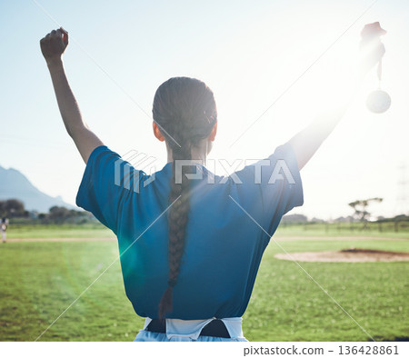 Sports, success and woman back with baseball medal at a stadium for victory, celebration or award. Softball, reward and female winner celebrating fitness target, match or competitive game performance 136428861