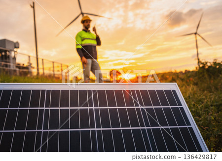 man is standing in front of a solar panel 136429817