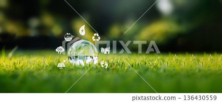 Sustainable development concept with glass globe and environmental icons: Net Zero, Recycling, and Green Energy 136430559