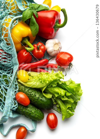 Fresh organic vegetables in a reusable mesh bag 136430679