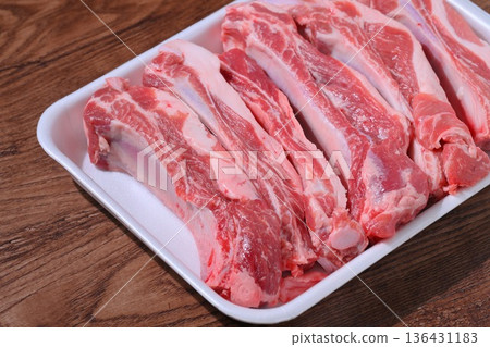 Note: This is uncooked raw meat and meat products. Pork spare ribs, pork belly on the bone, and BBQ meat. Note: This is uncooked raw meat and meat products. Pork spare ribs, pork belly on the bone, and BBQ meat. 136431183