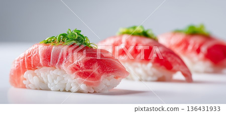 Fresh tuna nigiri sushi serving with green onion. Three pieces of fresh tuna nigiri sushi on a minimal white background 136431933