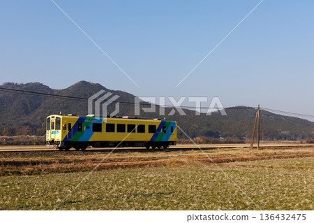 Heisei Chikuho Railway 400 Series "Nanohana" train running with Mount Umagatake in the background Heisei Chikuho Railway 400 Series "Nanohana" train running with Mount Umagatake in the background 136432475