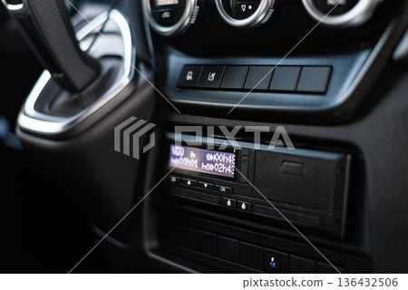 Professional truck tachograph and radio unit in dashboard console Professional truck tachograph and radio unit in dashboard console 136432506
