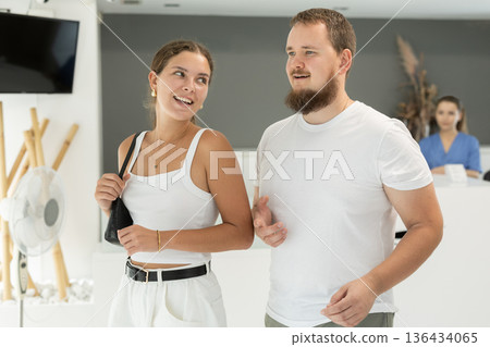 couple stands in front of the reception in the dentistry 136434065