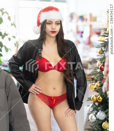 Young woman tries on lingerie and leather jacket Young woman tries on lingerie and leather jacket 136434117