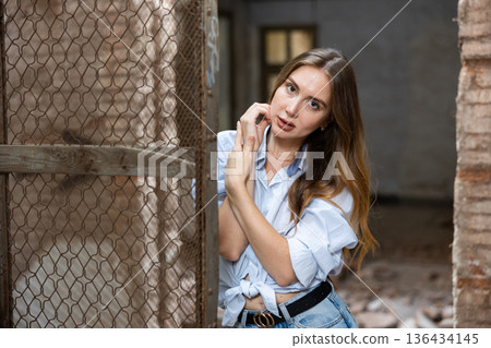 Portrait of attractive woman in abandoned building Portrait of attractive woman in abandoned building 136434145