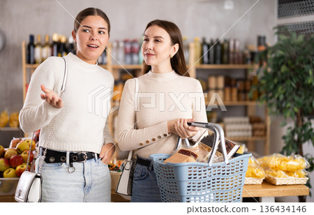 Two women shopping in a store 136434146