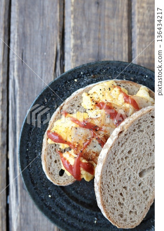 Berliner Landbrot sandwich: Scrambled egg sandwich on German rye bread 136434217