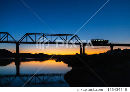A local train running over a railway bridge at dawn A local train running over a railway bridge at dawn 136434346
