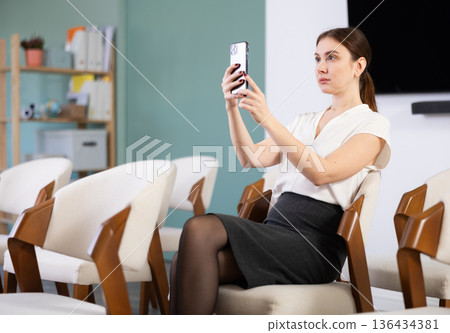 Girl student take pictures of screen at lecture Girl student take pictures of screen at lecture 136434381