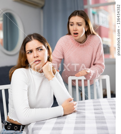 Girlfriend or sister yelling at girl during family quarrel Girlfriend or sister yelling at girl during family quarrel 136434382