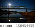 A local train running on a railway bridge under the moonlight 136434435