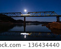 A local train running over a railway bridge at dawn 136434440