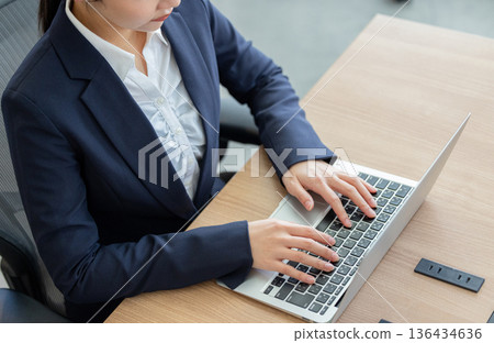 Woman working on a laptop Woman working on a laptop 136434636