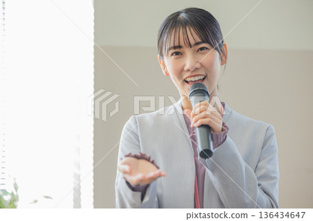 Young woman speaking with a microphone Young woman speaking with a microphone 136434647