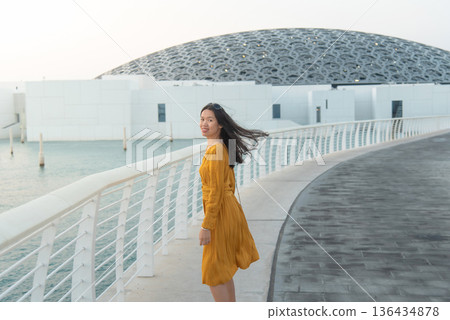 Fashionable Young Asian Woman in Yellow Outfit Outside Louvre Abu Dhabi United Arab Emirates 136434878