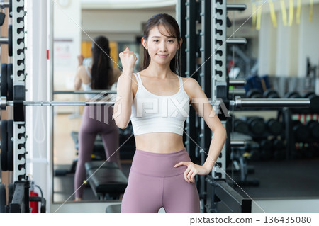 Young woman training in a sports gym Young woman training in a sports gym 136435080